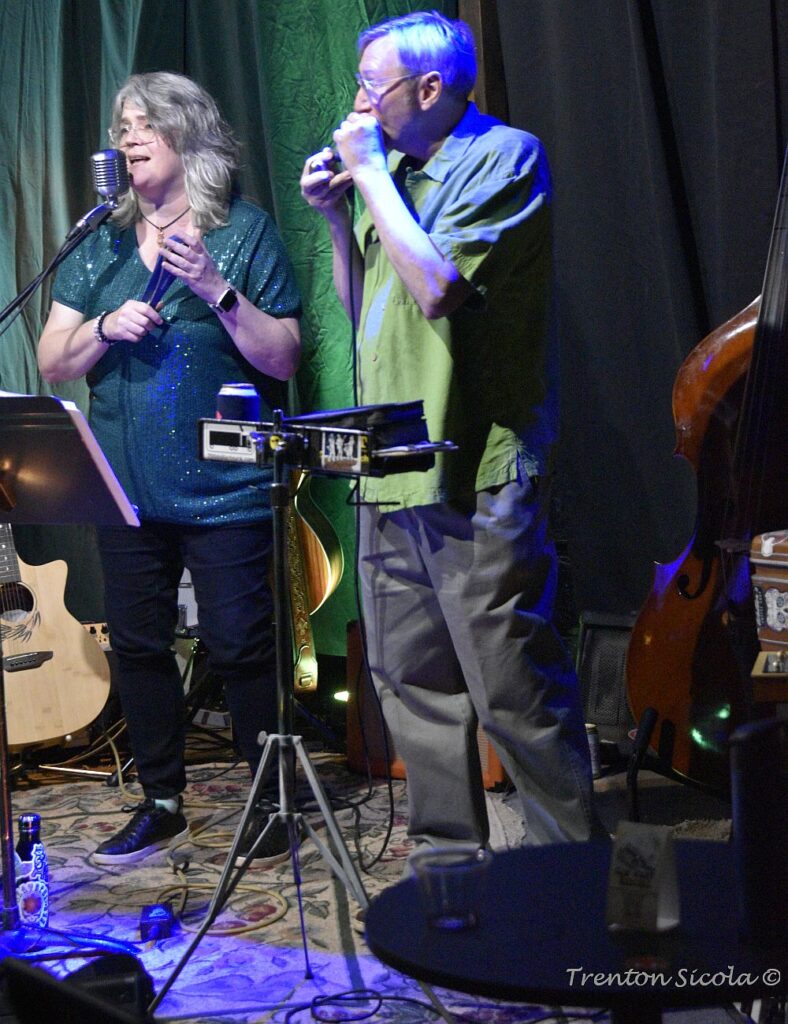 Conner plays harmonica while Patty looks on