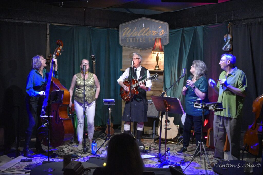 Gin Joint Rascals group pic on stage at Waller's Coffee Shop. Why is Sandy yelling?