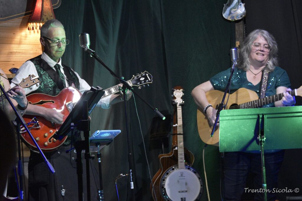 Matt Donald and Patty Richmond on stage with guitars