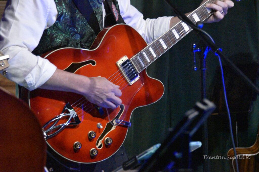 Close up of hand on guitar